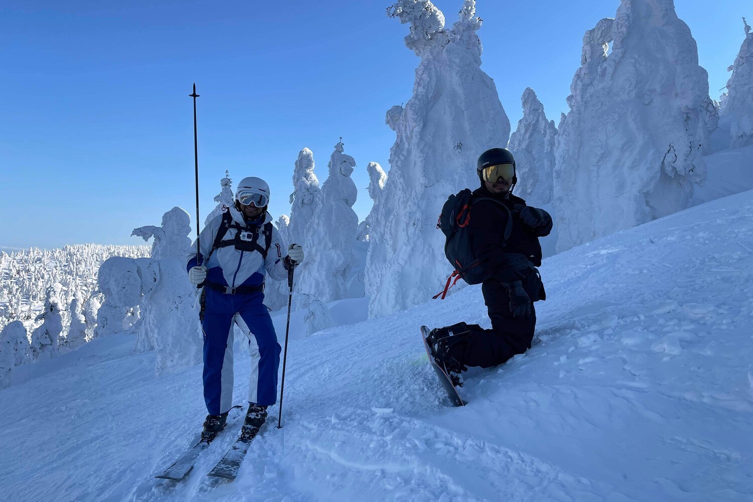 Aerial view of a tourer skinning beneath rocky alpine spires in the Japanese backcountry